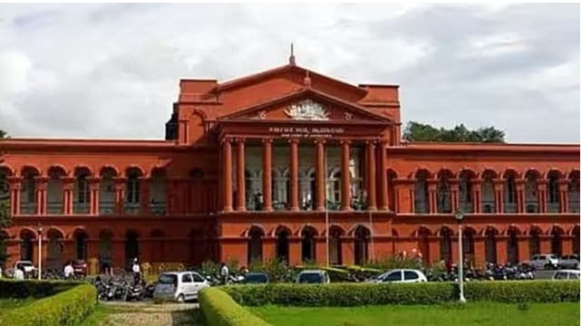 “Bike taxi riders waiting for passengers in Bengaluru before statewide ban enforcement”